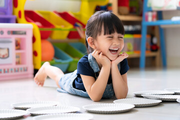 Adorable 3 years old is smiling with fully happiness moment while she playing indoor at home,...