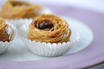 Baklawa or Bird's nest- an Arabic sweet served in a plate. Beautiful phot of Mediterranean authentic dessert.