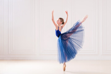 professional student ballerina doing pointe shoes in a beautiful white room