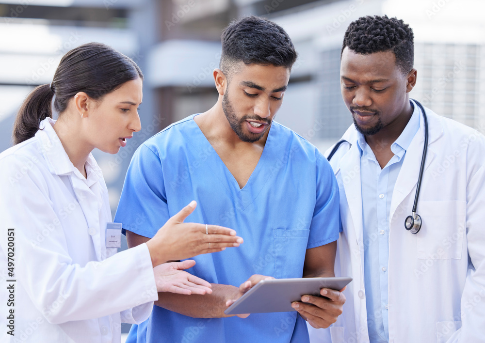 Aufkleber How do we fix this. Shot of a group of doctors using a digital tablet against a city background.