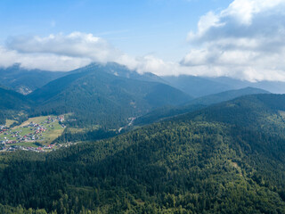 Green mountains of Ukrainian Carpathians in summer. Sunny day. Aerial drone view.