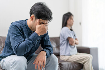 Asian man and woman are disappointed and saddened after an argument with wife. Asian couples are...