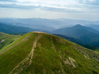 High mountains of the Ukrainian Carpathians in cloudy weather. Aerial drone view.