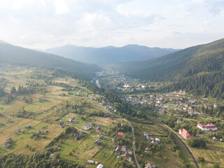 Fototapeta premium Green mountains of Ukrainian Carpathians in summer. Coniferous trees on the slopes. Aerial drone view.