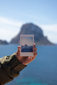 Holding a picture of Es Vedra in front of Es Vedra in Ibiza Spain