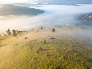 Fototapeta premium Fog in the Ukrainian Carpathians in the morning. Aerial drone view.