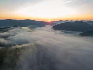 Sunrise over the fog in the Ukrainian Carpathians. Aerial drone view.