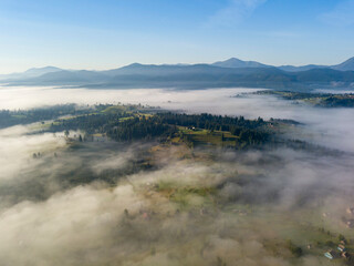 Morning fog in the Ukrainian Carpathians. Aerial drone view.