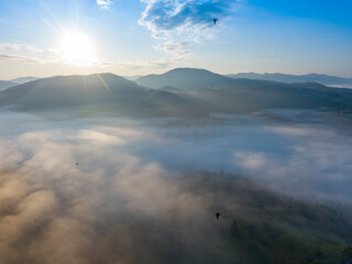 Sunrise over the fog in the Ukrainian Carpathians. Aerial drone view.