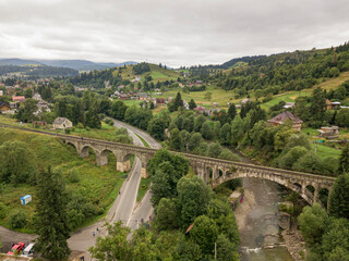 Fototapeta na wymiar Old railway bridge in the mountains. Ukrainian Carpathians. Aerial drone view.