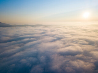 High flight above the clouds. Aerial drone view.