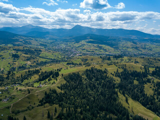 Obraz premium Green mountains of Ukrainian Carpathians in summer. Coniferous trees on the slopes. Aerial drone view.