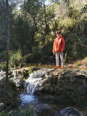 Fototapeta premium Teenager enjoying nature in a mountain river