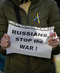 Details with the hands of an Ukrainian woman holding an anti war, pro Ukraine and anti Russia...