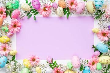 Colorful eggs and flowers on a white background. Easter design in pastel colors with space for text. Holiday template, top view.
