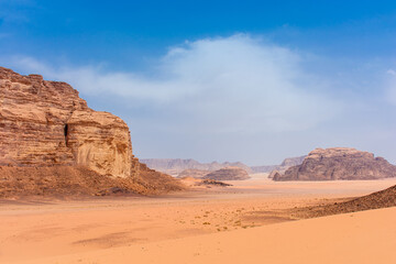 Fototapeta na wymiar Sands and mountains of Wadi Rum desert in Jordan, beautiful daytime landscape
