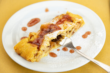 very good dessert with apples, jam and pine nuts called strudel
