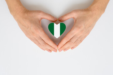 The national flag of Nigeria in female hands.