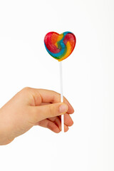 Heart shaped lollipop on white background