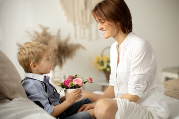 Mother and child, blond fashion preschool boy, having a wonderful family happy moment together