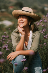 Thai woman is sitting on a stump in flower field