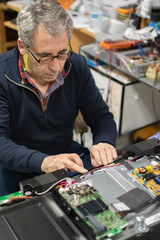 technician repairing a television.