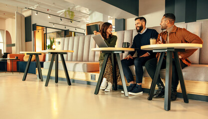 Team of businesspeople working together in an office lobby