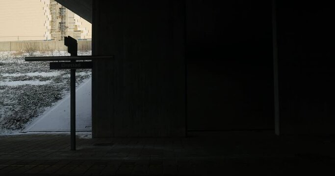 View from the train arriving in the dark Orestad station metro station platform - developing city area in Copenhagen, Denmark, on the island of Amager. The area was developed using the new town concep