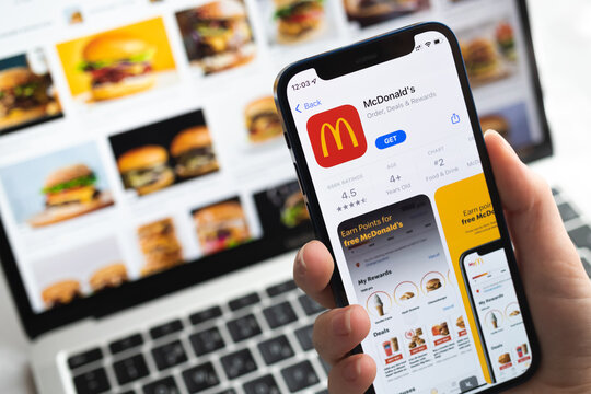 McDonalds app icon. Hand with mobile phone with application. Fast food concept photo