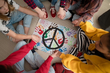 Top view of students praying for peace in world at school.