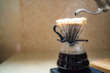 Making pour over coffee with dripper, carafe and kettle