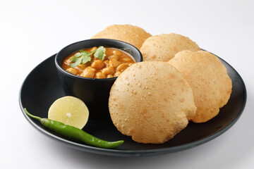 Puri and Chole traditional Indian food 
Indian dish spicy Chick Peas curry also known as Chola/Chana Masala or commonly Chole, served served with fried puri or poori  