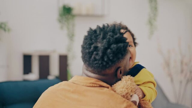 Black father tickling his baby and enjoying child's laughter, happy family - Powered by Adobe