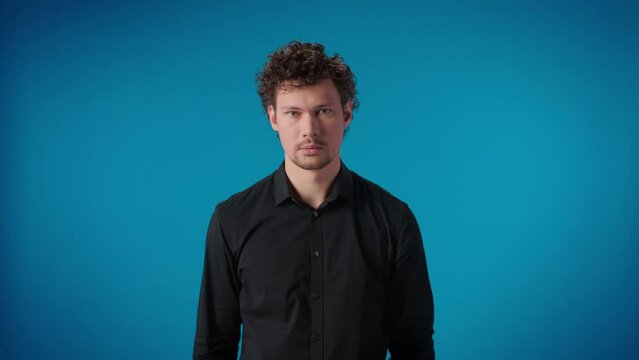 Portrait funny arrogant curly male touching eyebrows fooling having fun posing isolated