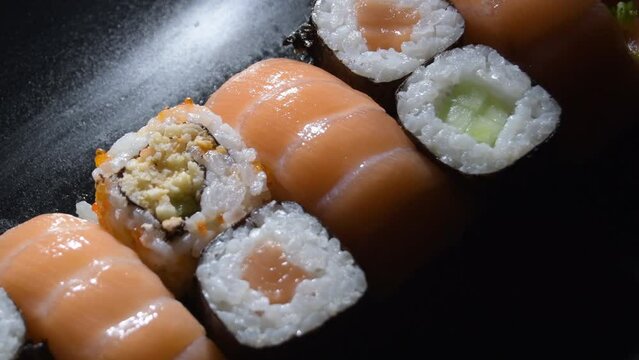 Salmon and Sushi Rolls Gyrating with a intimate light