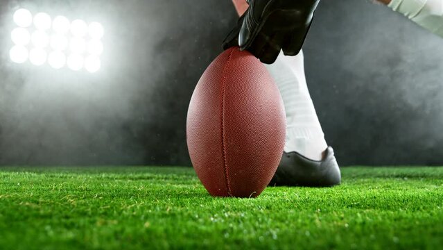 Super slow motion of American football player kicking the ball. Filmed on high speed cinema camera, 1000fps.