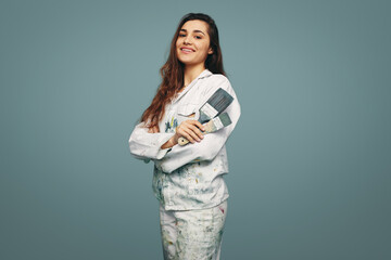 Female painter smiling at the camera in a studio