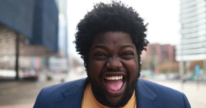 Happy african plus size man smiling on camera outdoor