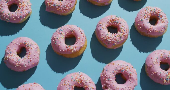 Video of donuts with icing on blue background