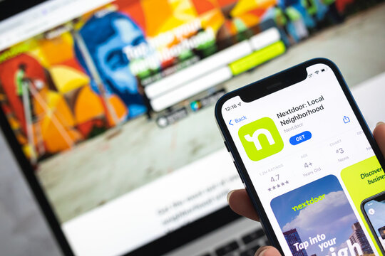 Nextdoor App icon. Mobile phone with Nextdoor Local Neighborhood application