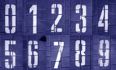 Numbers from zero to nine on pavement in blue tone.