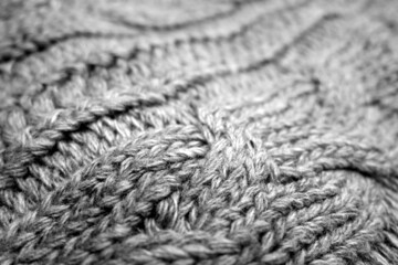 Warm knitting texture with blur effect in black and white.