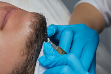 Injection plasma into beard hair man cosmetologist doctor.