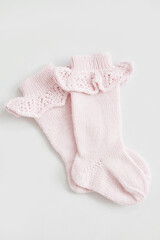 Knitted socks, kids clothes and accessories for knitting. Needlework and knitting. Hobbies and creativity. Knit for children. Handmade. Hobbies and creativity