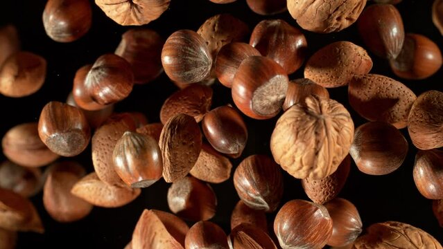 Super Slow Motion Shot of Flying Mix of Whole Nuts Towards Camera Isolated on Black at 1000fps.