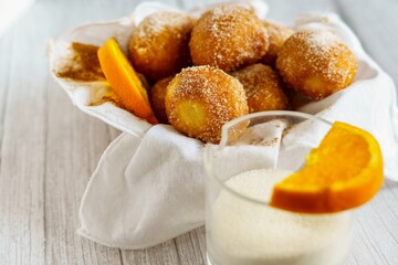 Homemade wind fritters with cinnamon sugar and orange. Grandma's recipe