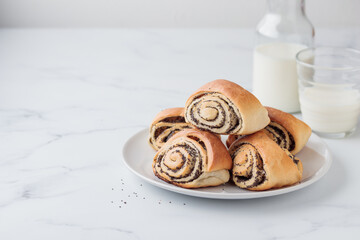 Sweet homemade poppy seed buns with milk for the breakfast