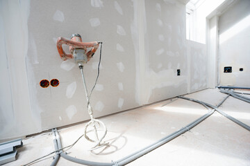 Attic finishing construction site in the phase drywall spackling and plastering before screeding