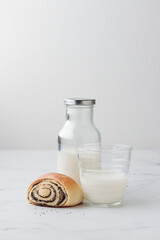 Sweet homemade poppy seed buns with milk for the breakfast