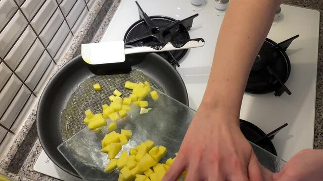 Preparing scrambled egg with potato pepper and mushroom at home for sunday breakfast  